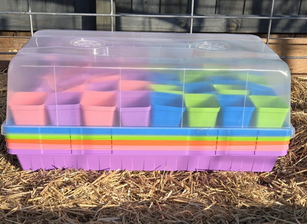 Seen in the photo above is a Bootstrap Farmer growing kit. This is the multi-color package, as you an see the different tray colors stacked up. In the top tray, there are 2.5 inch pots nestled inside and a humidity dome on top. 